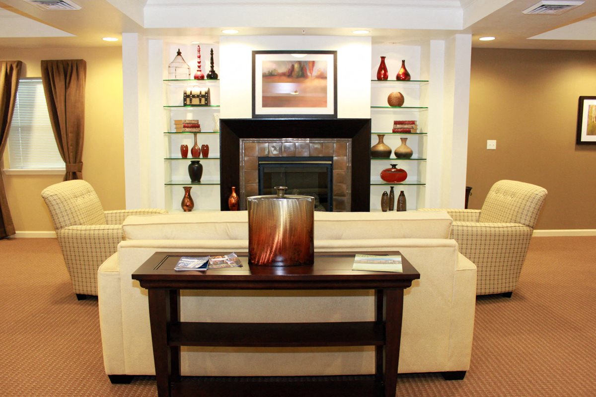 Resident Clubhouse, large seating area, two sofa chairs, fireplace